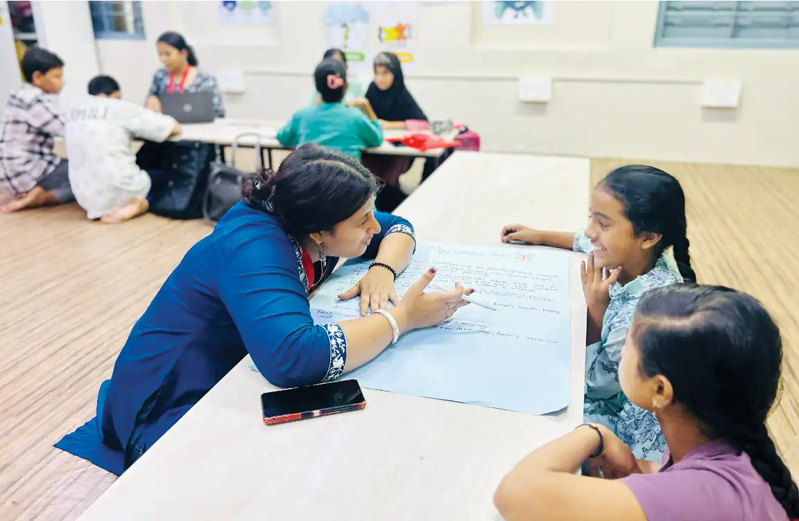 Teacher guiding students in a classroom